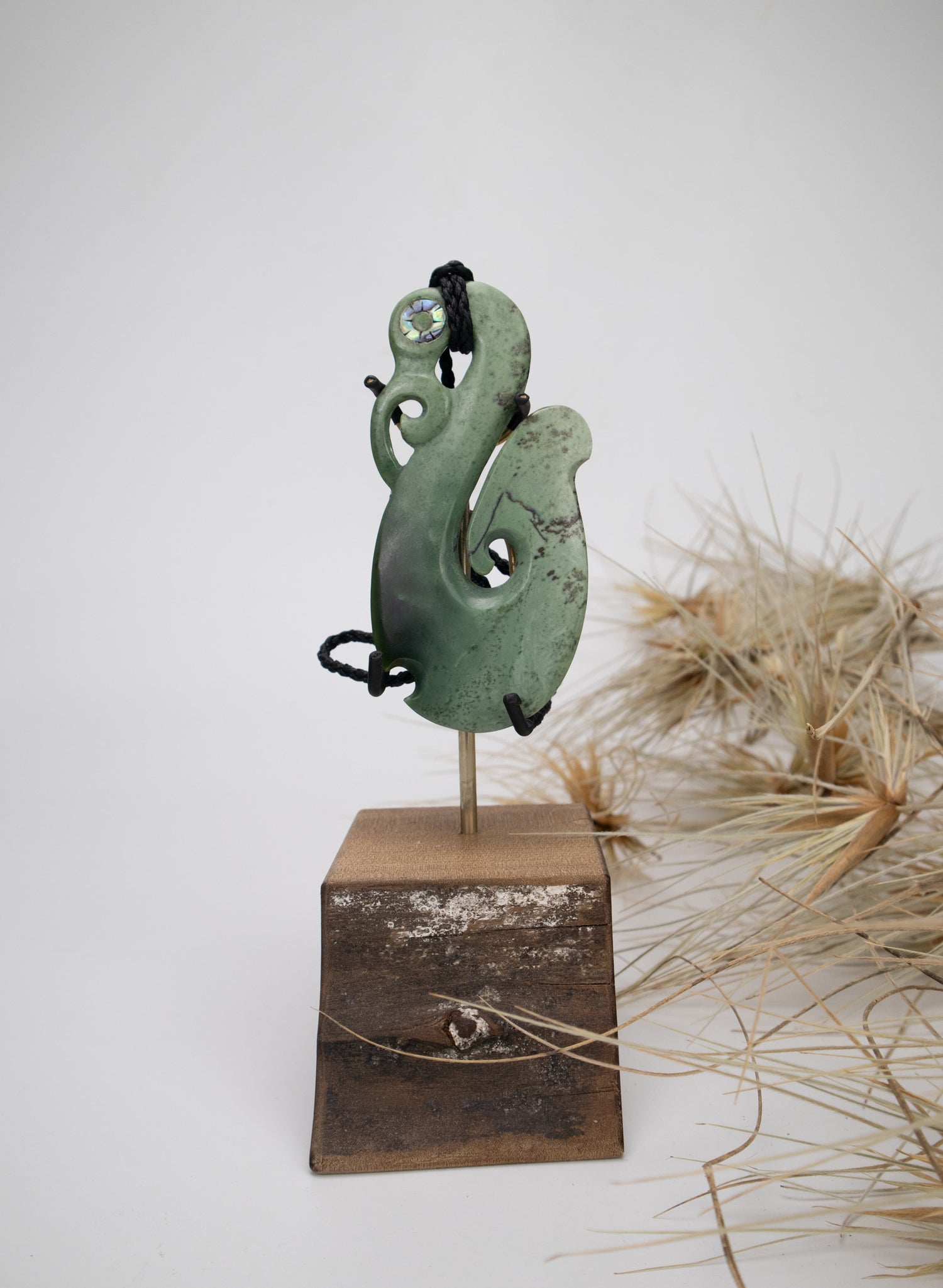 Carved Pounamu Manaia Pendant on Stand