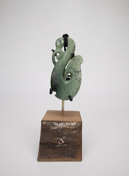 Carved Pounamu Manaia Pendant on Stand