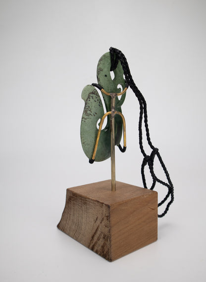 Carved Pounamu Manaia Pendant on Stand